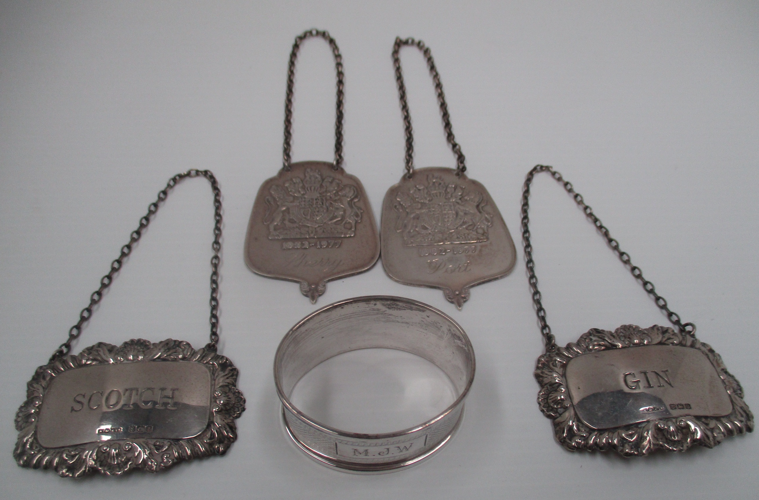 A pair of Silver Jubilee [1977] silver decanter labels cast with the Royal Coat of Arms,