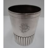 A Victorian silver beaker of tapered cylindrical form with raised lower section, Birmingham 1884,