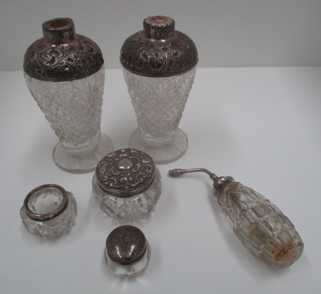 A pair of baluster glass scent bottles with embossed silver shoulders, dressing table jars, etc.