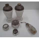 A pair of baluster glass scent bottles with embossed silver shoulders, dressing table jars, etc.