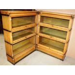 Two three height sectional bookcases with lifting glazed panel doors (one door missing),
