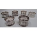 A silver napkin ring with engine turned decoration, engraved R.M.S.