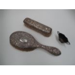 A clothes brush with art nouveau style embossed back,