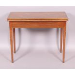 An early 19th century mahogany folding tea table with rectangular top on square tapered chamfered