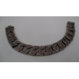 A gentleman's silver bracelet of flattened bark effect curb links [approximate weight 3.1oz].