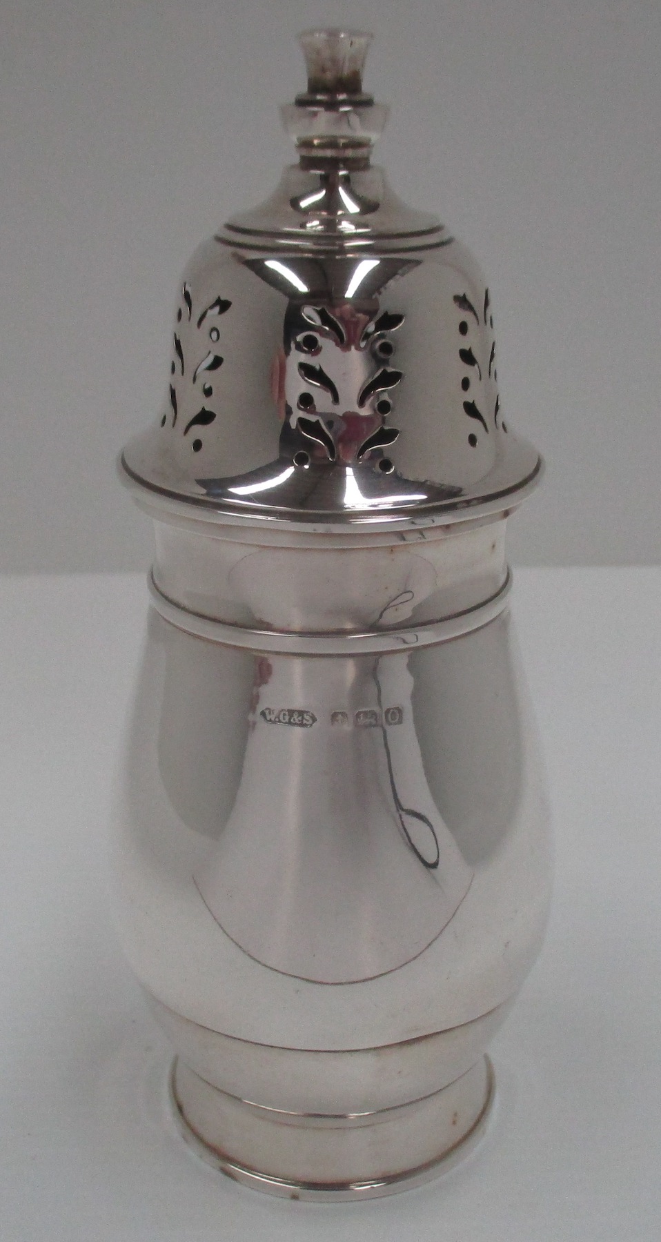 A silver sugar caster with pierced domed cover and baluster body for W.