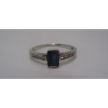 A Sapphire ring, the rectangular stone set in white gold (tested 18ct) with diamond shoulder (2.