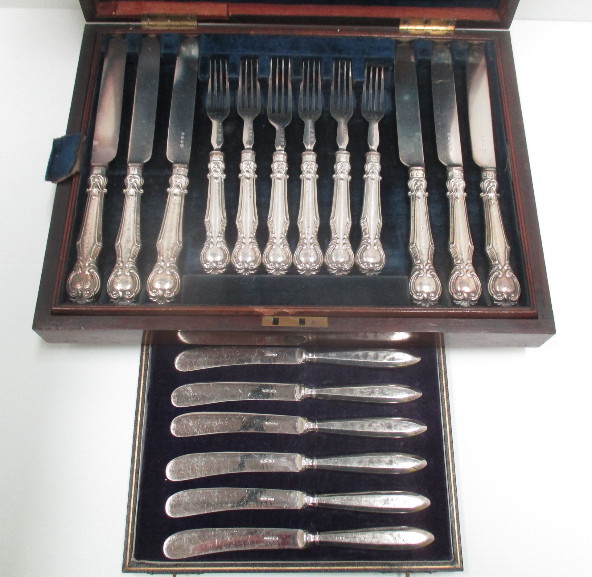 A set of twelve pairs of Victorian dessert knives and forks with embossed silver cased handles in - Image 2 of 2