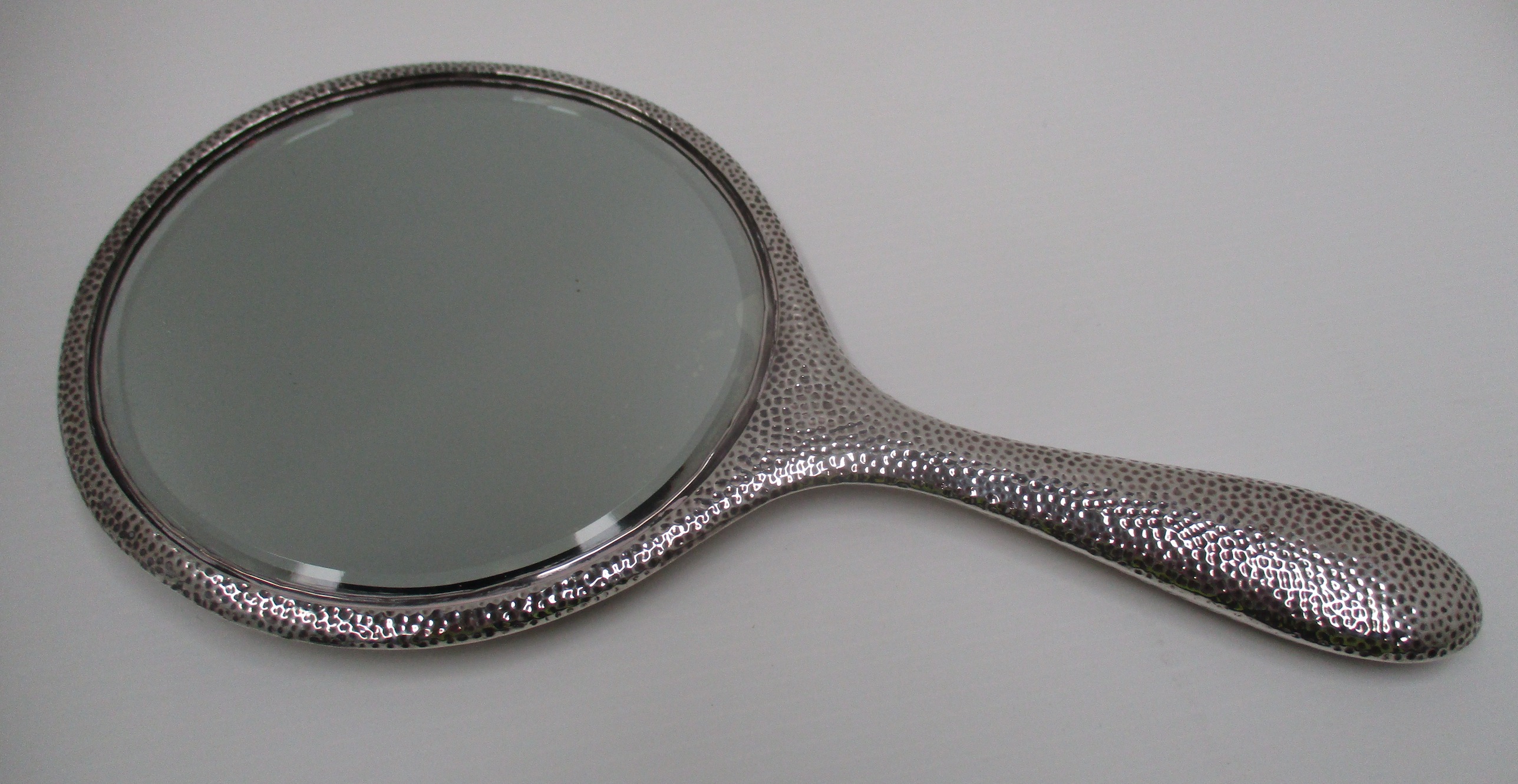 A circular hand mirror with hammered finish, silver back and cased handle. - Image 3 of 3