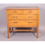 An oak chest of two short and three long drawers with floral carved narrow friezes,