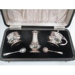 A three piece silver condiment set, the baluster bodies with raised mid bands,