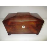 An early 19th Century sarcophagus shape rosewood two division tea caddy on flattened bun feet 28cm