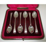 A set of six silver Old English pattern coffee spoons with floral engraved handles,