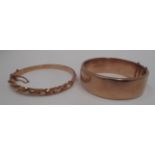 A 9ct gold hinged bangle with leaf scroll engraving and a rope twist bangle [unstamped] [2].