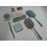 Silver cased dressing table accessories with turquoise enamel engine turned decoration [7].