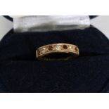 A half hoop eternity ring set with diamonds and rubies in 18ct gold [total approximate weight 2.