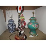 A Murano type glass clown table lamp and two pottery vase table lamps,