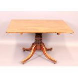 An early 19th Century mahogany breakfast table with tipping rectangular top on heavy baluster and