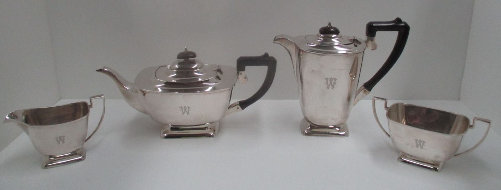 A four piece silver tea service of oval boat shape, on plinth base,