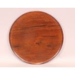 A circular mahogany tray with moulded rim 58cm