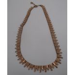 A 9ct gold necklace of textured "icicle" panels [approximate weight 18.3g].