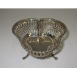 A silver tri-lobe bowl with moulded rim and pierced sides, on three scroll feet, Birmingham 1909,