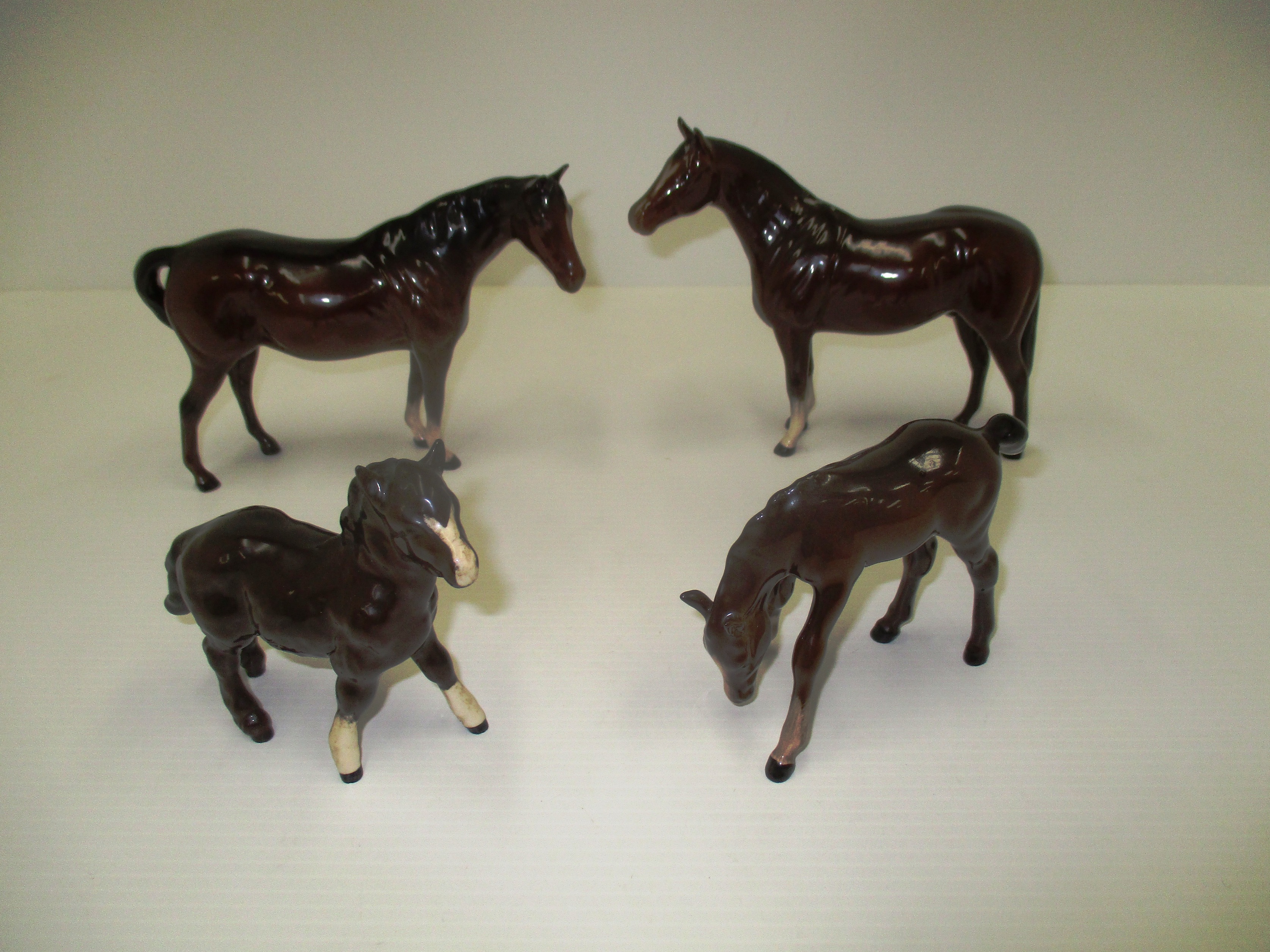 Three Royal Doulton ponies and a foal in brown gloss [4]