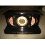A French movement mantel clock in a polished black slate case with rouge marble panels 26.