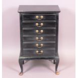 An ebonised music cabinet of six Stones patent drop-front drawers, on cabriole legs 0 53 cm.