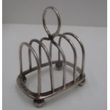 A silver four division toast rack of arched form for Goldsmiths and Silversmiths Co. Ltd.