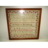 A sampler worked in cross stitch with the alphabet by F Bailey aged 12,