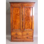 A Victorian mahogany wardrobe, the cornice and door panels with applied rippled moulding,