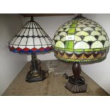Two Tiffany style table lamps each with leaded glass shade,