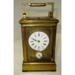 A brass cased striking carriage clock with lever movement (19cm handle up x 9cm) Further