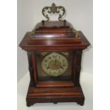 A mahogany cased mantel clock with brass dial and brass handle (45cm handle up x 26cm)