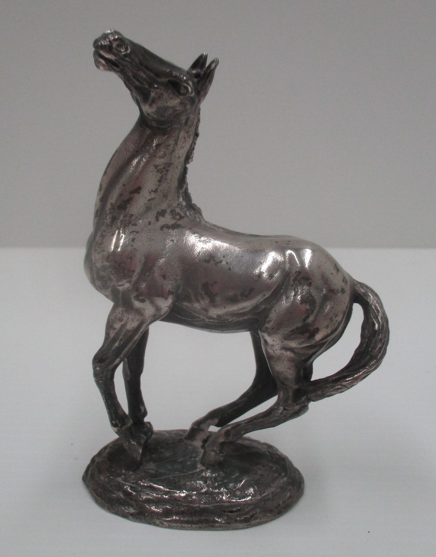 A cast silver model of a horse, 1975, import mark, 11.5 cm [total approximate weight 19.7 oz].