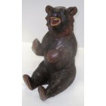 A Black Forest carved seated bear 34.