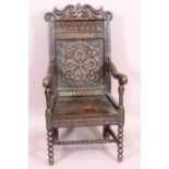 A Victorian Jacobean style oak armchair with scroll crest over carved panel back,