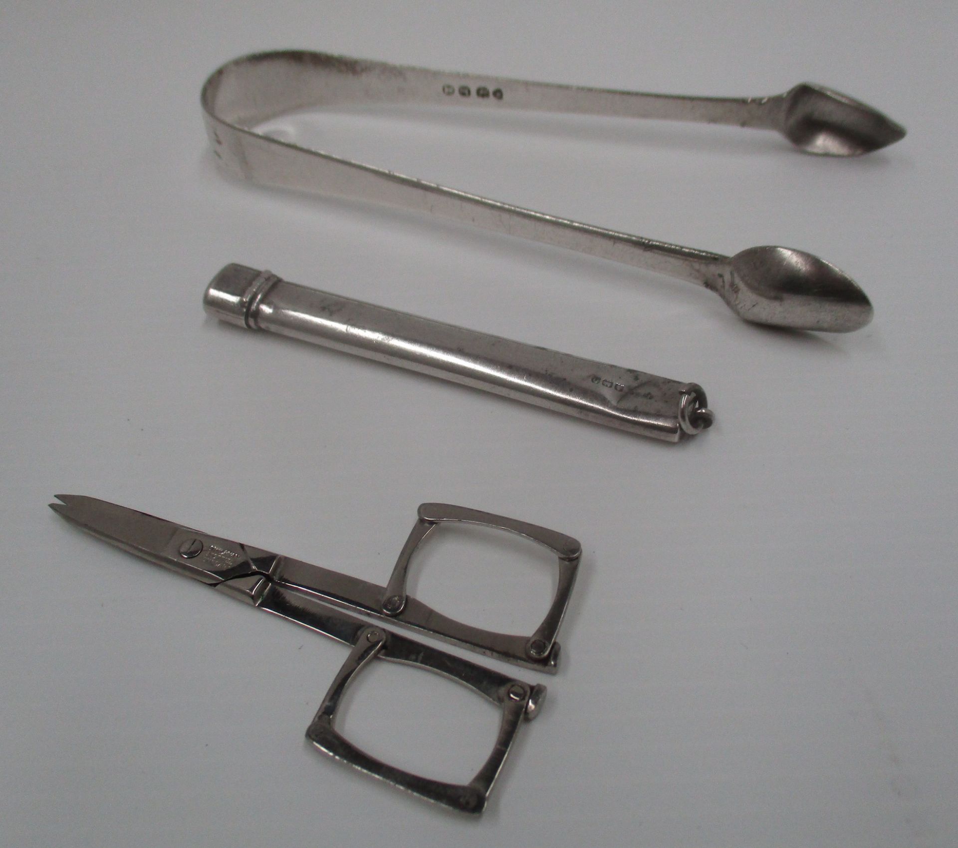 A pair of plain William IV silver sugar tongs by J. H. & C.