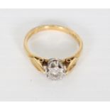 A solitaire diamond ring in 18ct gold setting with leaf shoulders [approximate weight 2.8g].