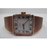 A lady's Longines wristwatch with square dial in a 9ct gold case with 9ct gold integral bark effect