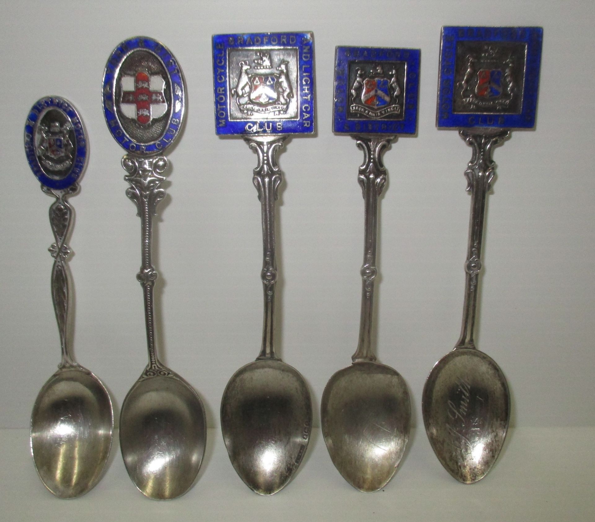 Four silver trophy teaspoons with enamelled crests for Bradford Motor Cycle Club and another,