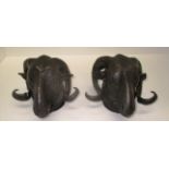 A pair of cast bronze wall brackets modelled as rams heads 18cm (2)