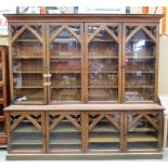 An oak Gothic style two height bookcase,