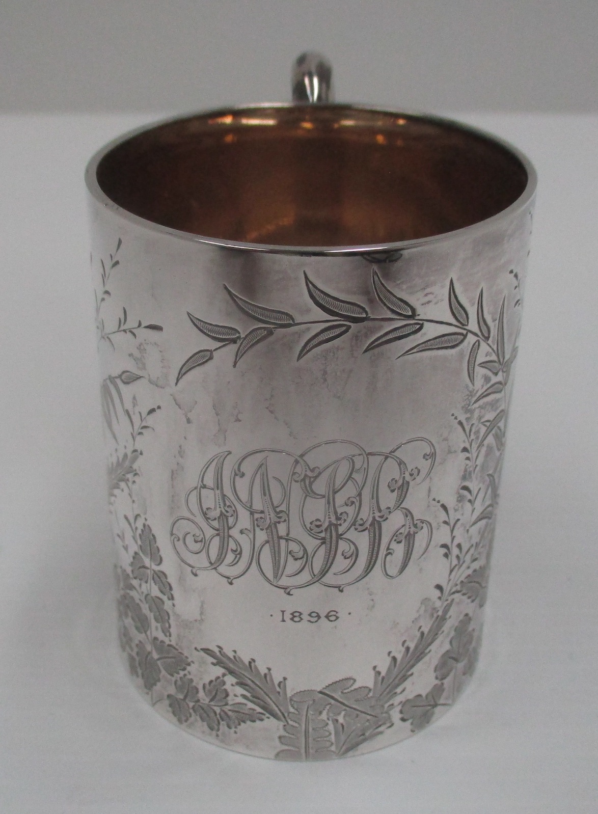 A Victorian silver cylindrical mug with fern and floral etched decoration, Sheffield 1893, 8 cm.