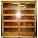 A ten section mahogany double bookcase with lifting glazed panel doors the base with two drawers