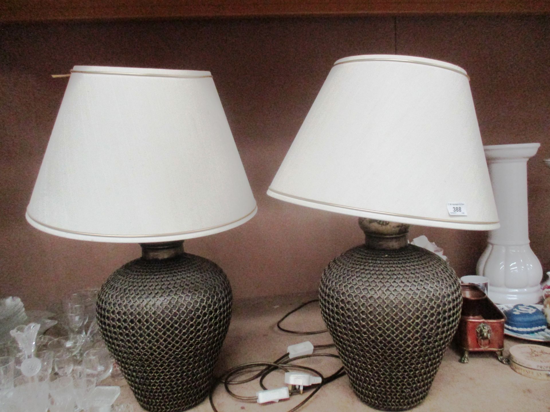 A pair of multi chain design vase lamps with cream shades