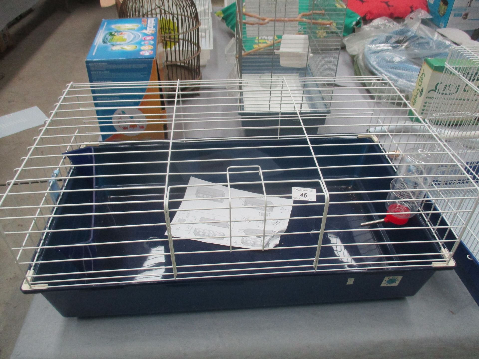 A Global pet rabbit cage with water bottle