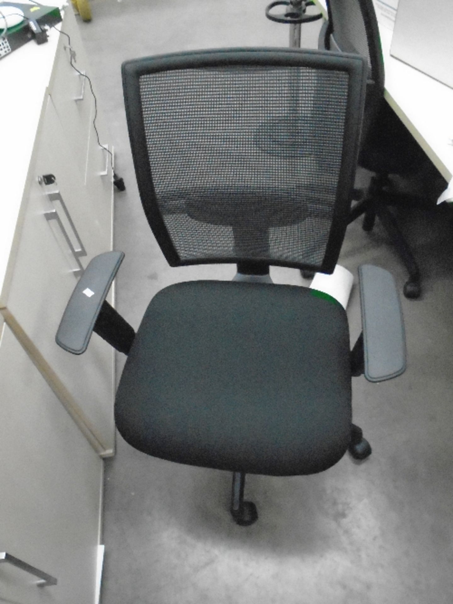 A Vector black upholstered operators swivel arm chair with netted back support