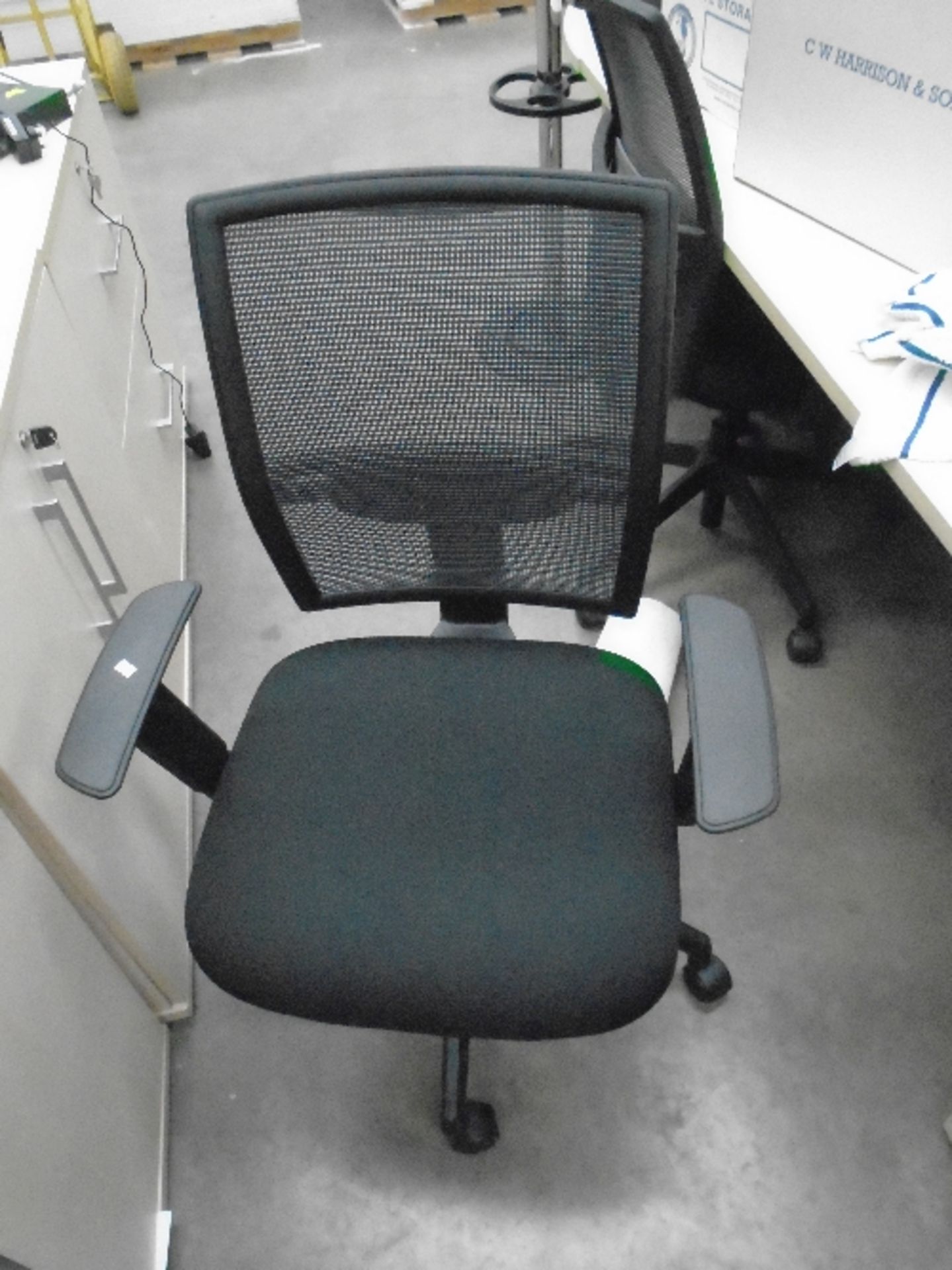 A Vector black upholstered operators swivel arm chair with netted back support